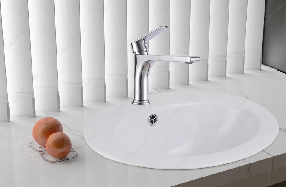 Countertop oval basin with chrome mixer
